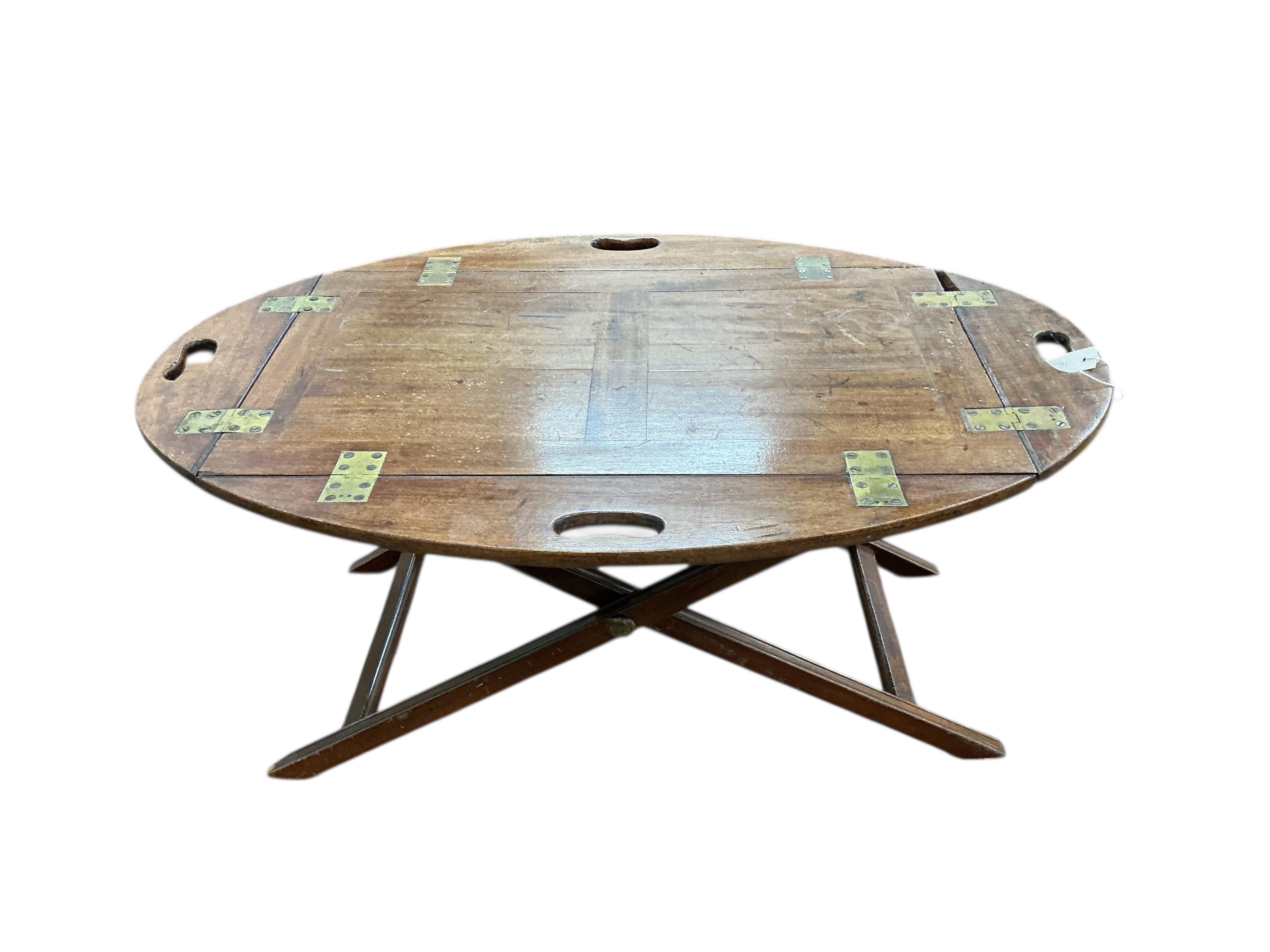 A George III style oval mahogany butler's tray on folding stand, width 70cm, depth 42cm, height 52cm